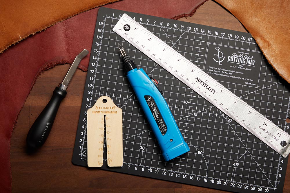 From left: roughing tool, thickness gauge, thread burner and ruler. Behind: Sailrite double-sided cutting mat.